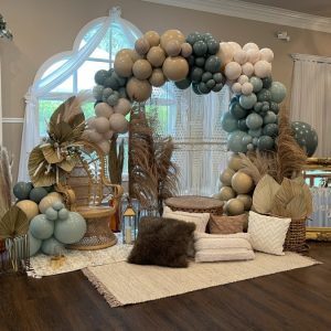 Beige, blue, and white balloon arch for baby shower