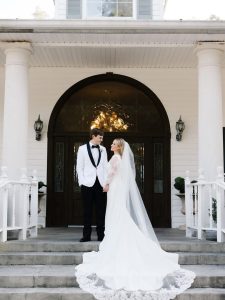 bride and groom standing in a doorway